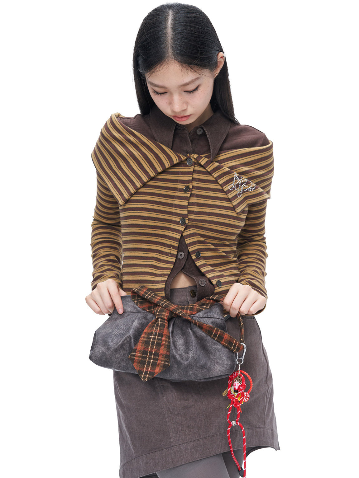 Side studio view showing the draped wide collar and striped knit of the NEXT PASSPORT cardigan