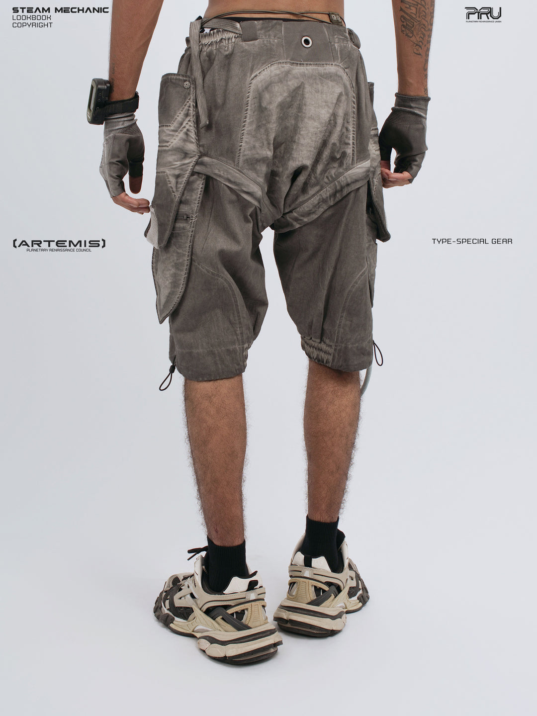 ARTEMIS xirang brown detachable technical shorts — rear modeled view with hands down