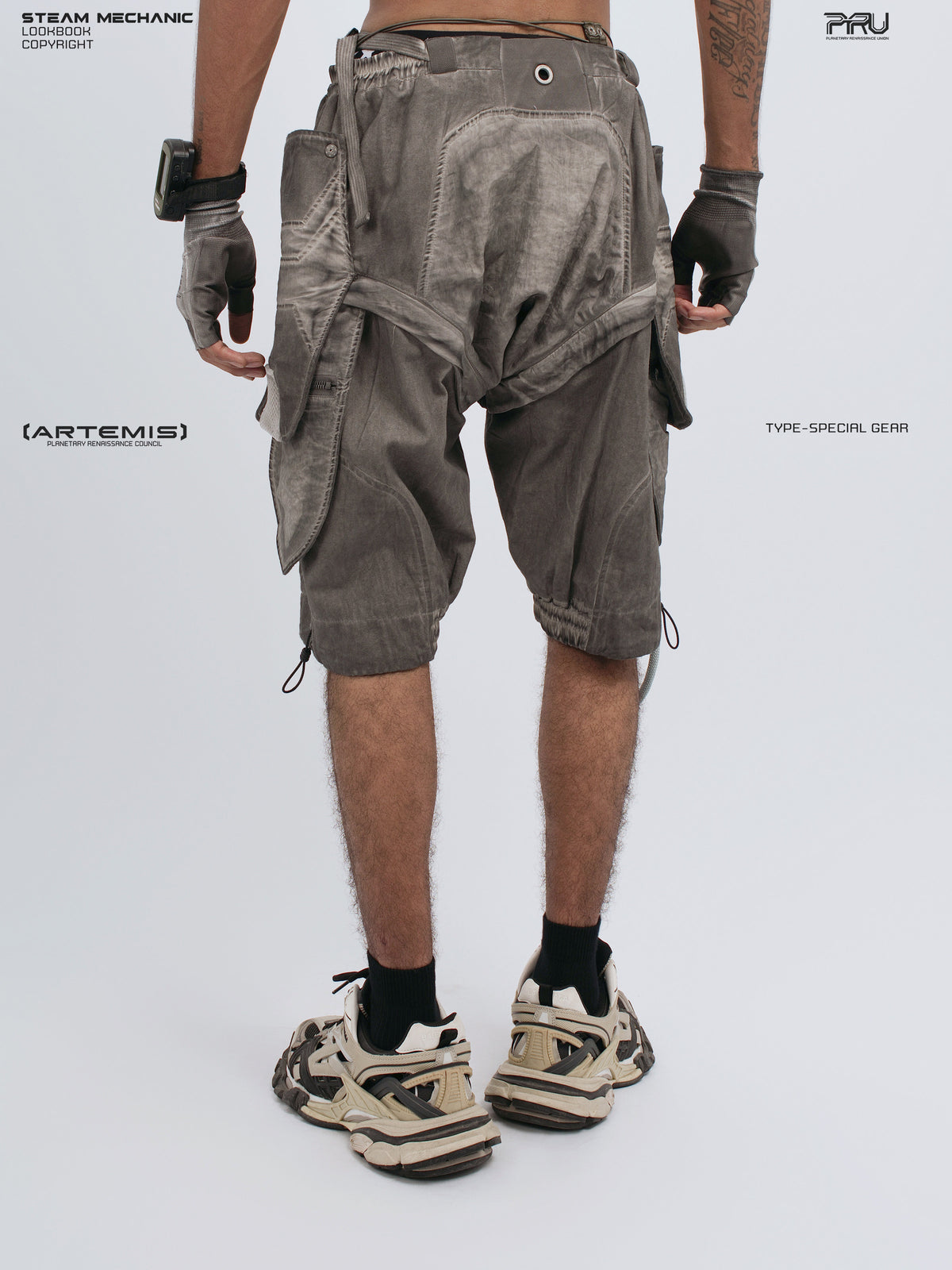 ARTEMIS xirang brown detachable technical shorts — rear modeled view with hands down