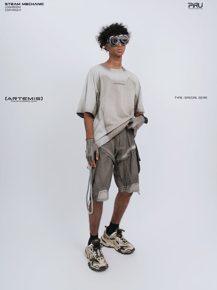 ARTEMIS xirang brown detachable technical shorts — full-length styled view with gray tee and one hand raising its hem