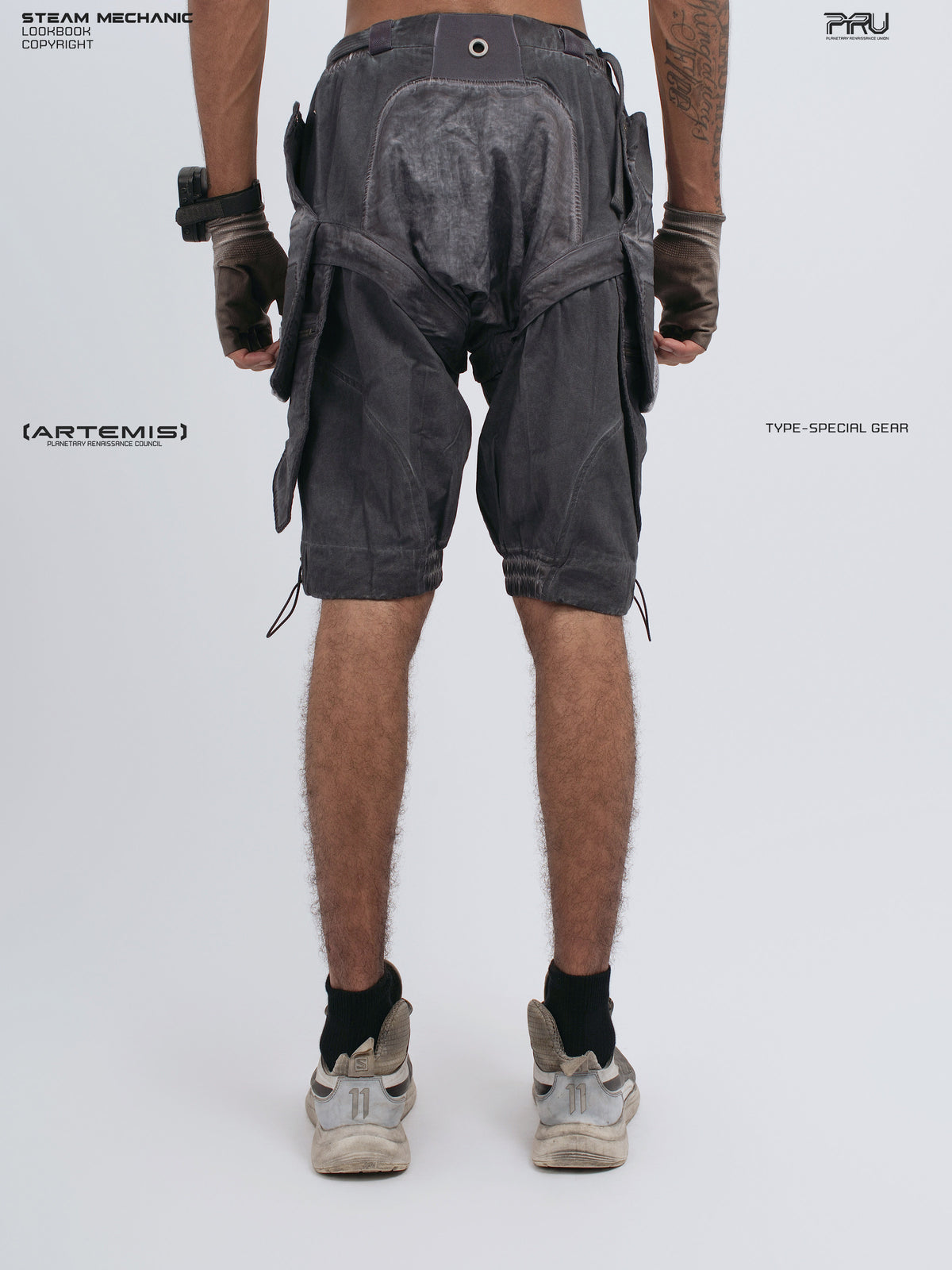 ARTEMIS stellar blue detachable technical shorts — rear modeled view with hands down