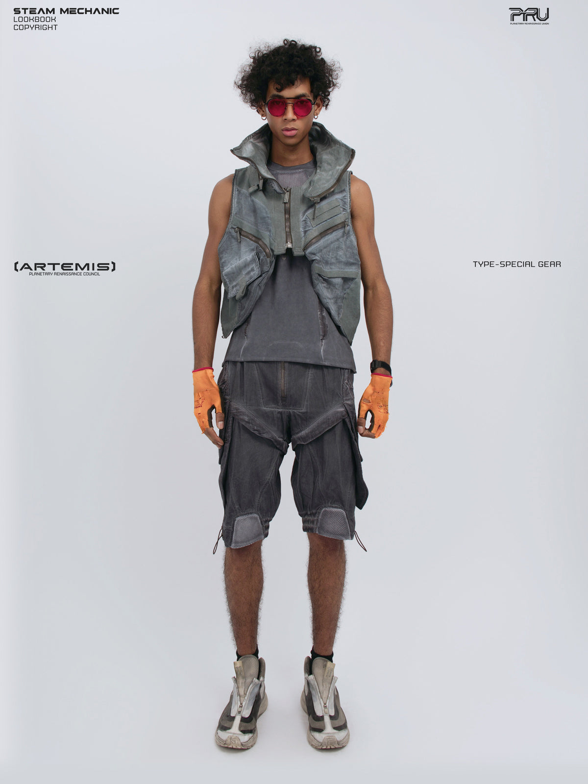 ARTEMIS stellar blue detachable technical shorts — full-length styled view with matching vest and orange gloves