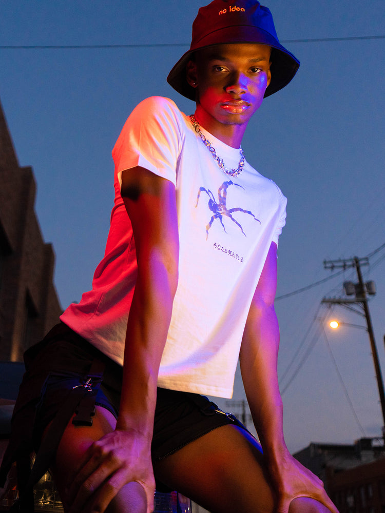 NO IDEA hat, black bucket hat in a neon-lit waist-up streetwear portrait