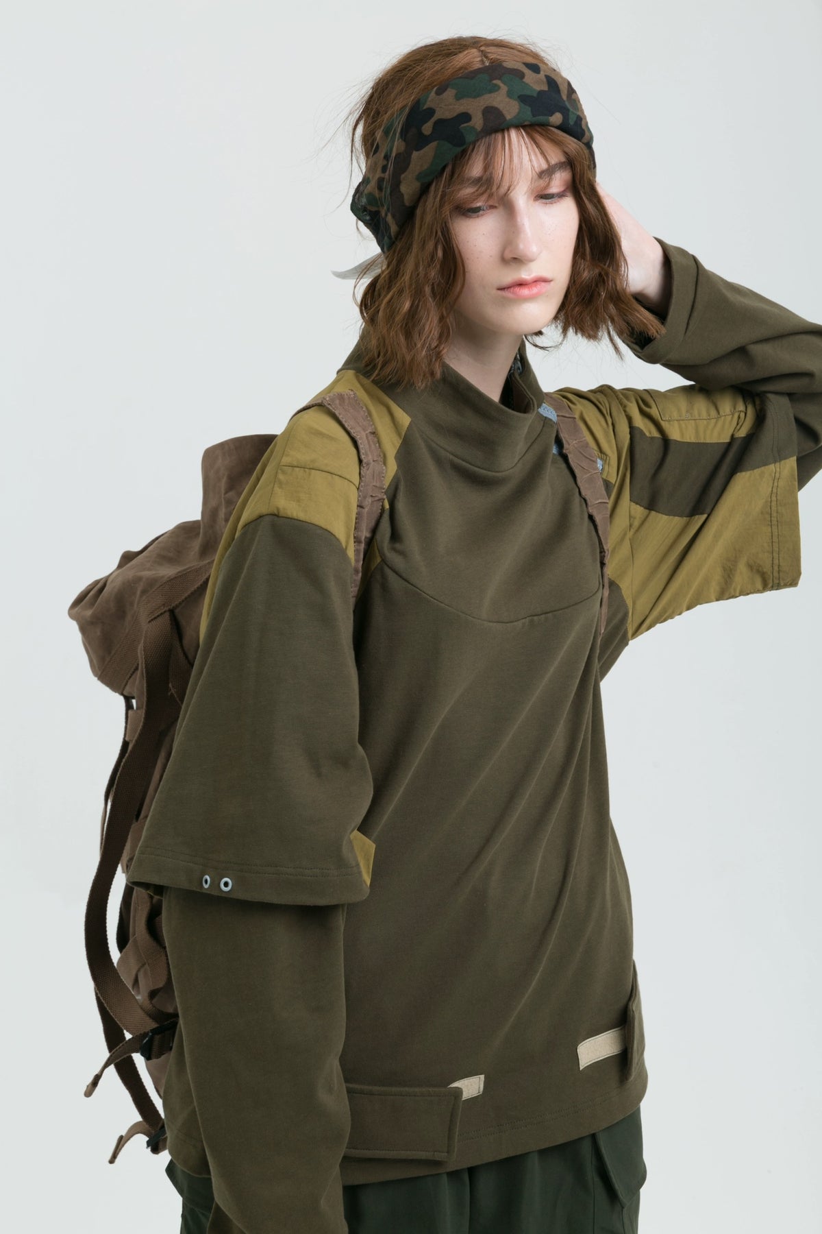 ERRORCODE ROBOT detachable-sleeve multi-pocket sweatshirt, front modeled view with one hand at the neck