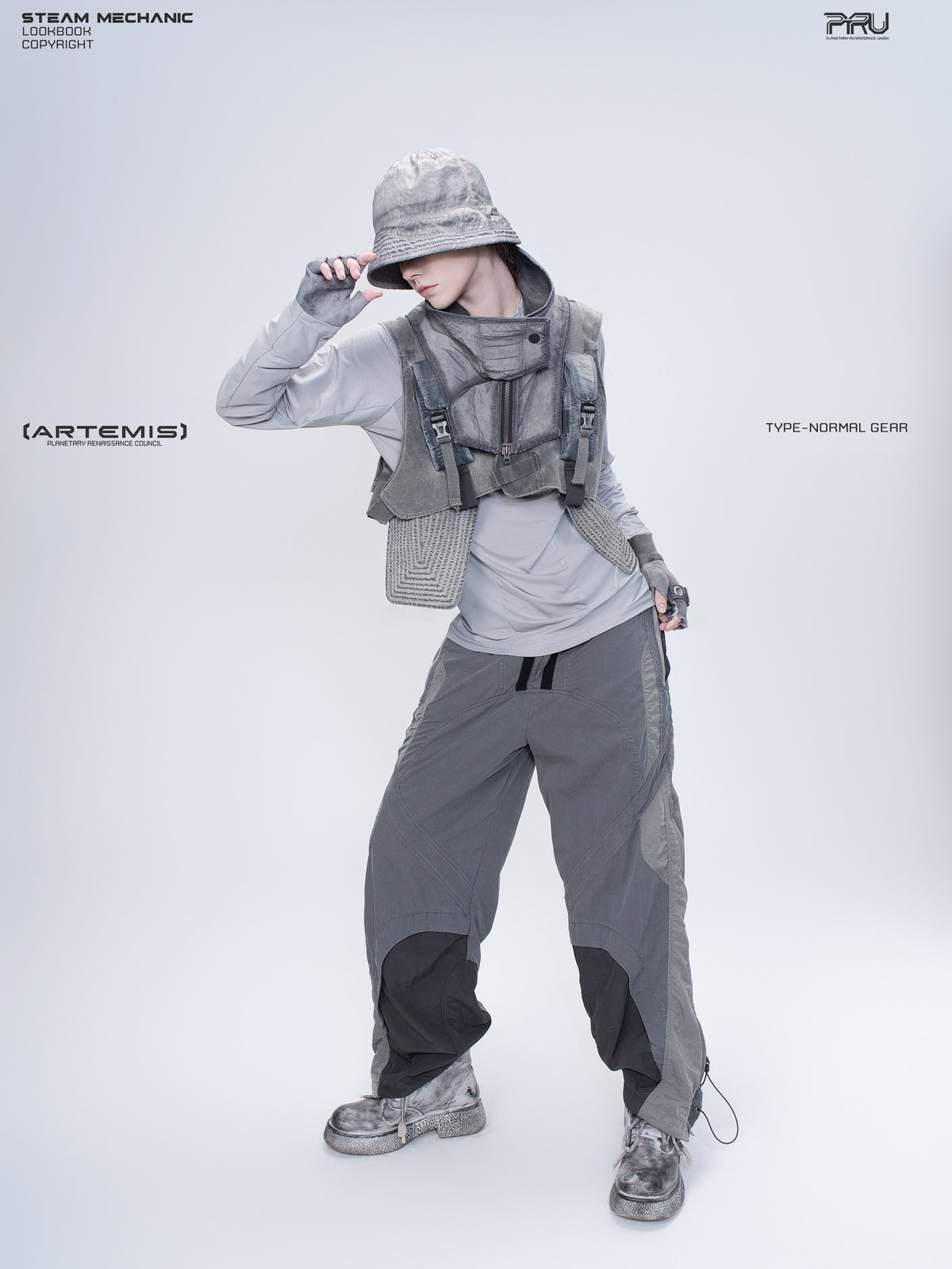 ARTEMIS moon dust gray stretch technical base-layer top — front modeled view with one hand at the hat