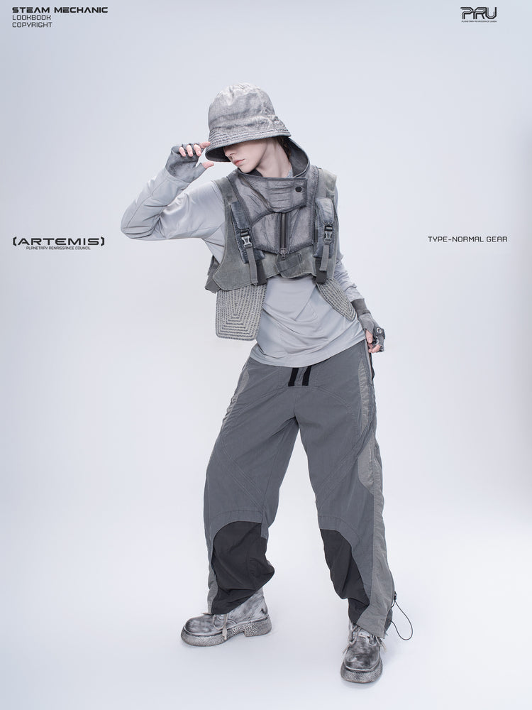 ARTEMIS moon dust gray stretch technical base-layer top — front modeled view with one hand at the hat