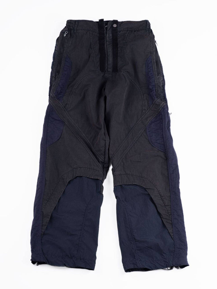 SUPERNOVA zima blue metallic nylon technical pants — zima blue front flat-lay showing dark contrast panels and zip pockets