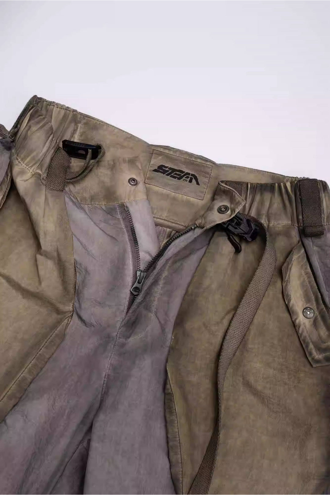 STARCORE mercury brown engineer utility pants — inner waistband, fly zipper and brand label close-up