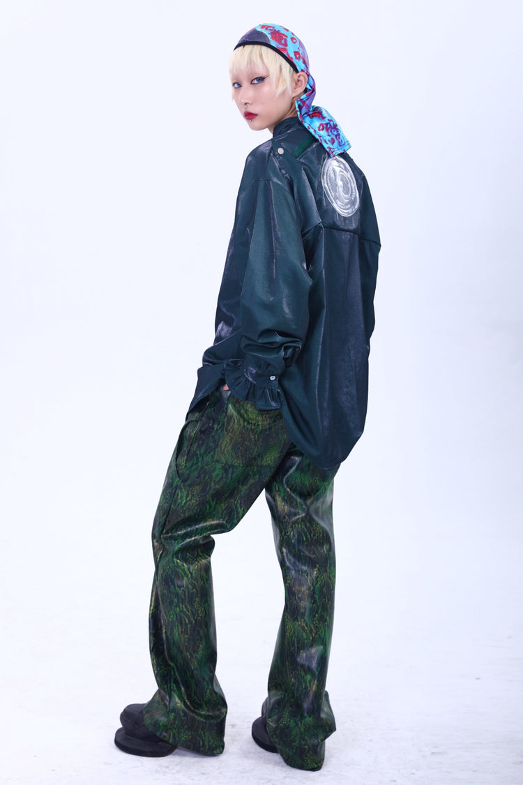 EMBRYO TRIANGLE ARMOR lace-inset leather pants in green — rear three-quarter modeled outfit with green overshirt