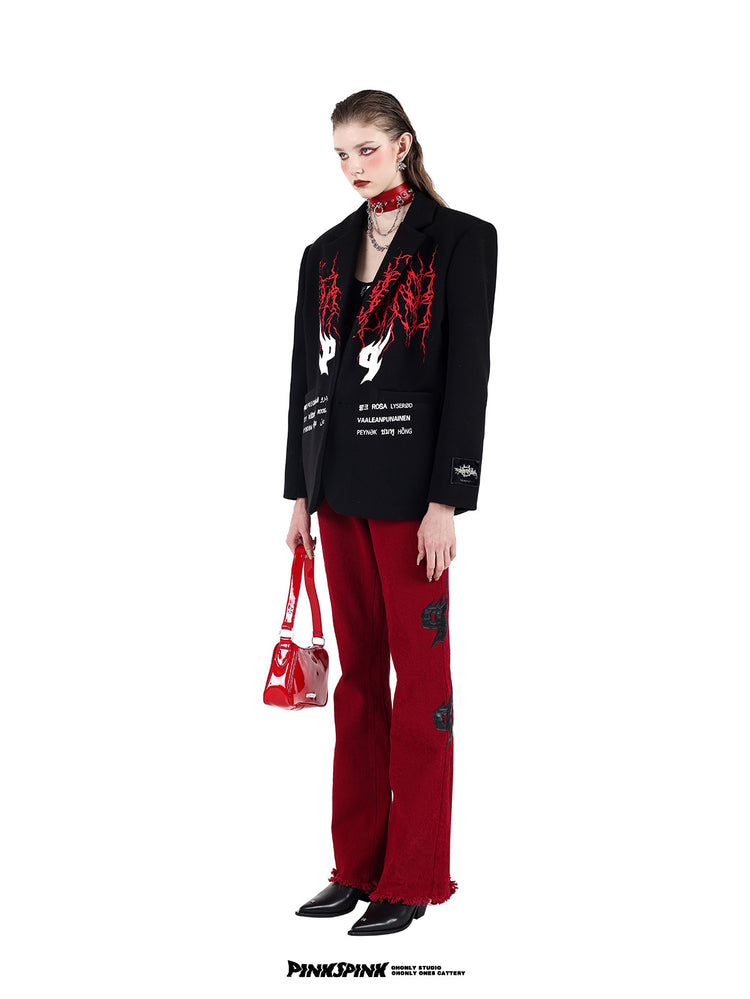 PINKSPINK SPIKE RING studded chain choker in red — three-quarter full-length modeled view with an embroidered blazer, red trousers and bag