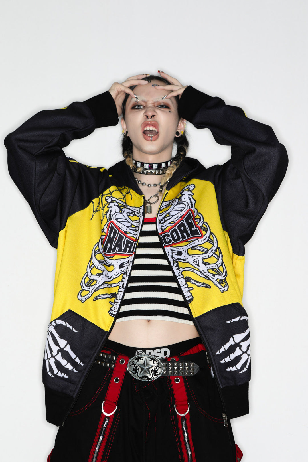 DeadEndKids Hardcore Generation skeleton zip-up hoodie — modeled front, hands to head