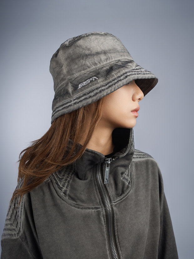 PIONEER distressed nylon bucket hat in moon dust gray — side modeled view showing crown height and brim shape