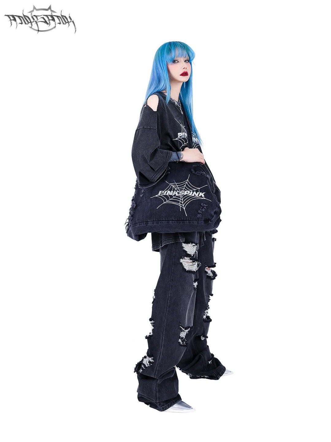 PINKSPINK SPIDER distressed denim shoulder tote — side full-length modeled view carrying the tote over one shoulder