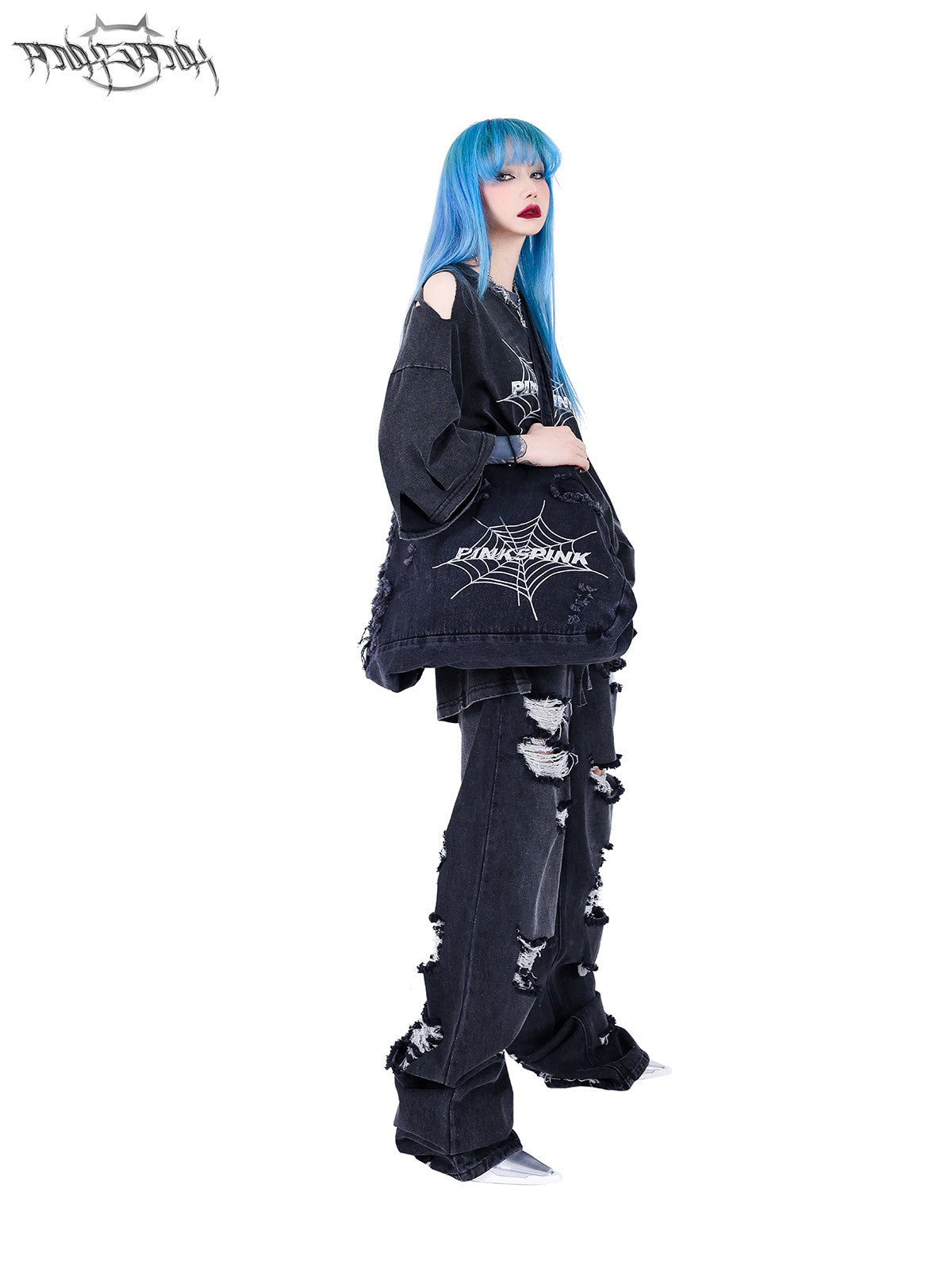 PINKSPINK SPIDER distressed denim shoulder tote — side full-length modeled view carrying the tote over one shoulder