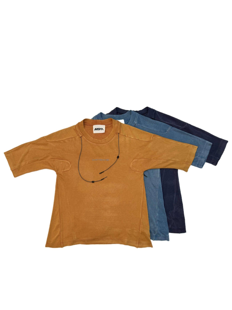 LIGHTSHADOW eclipse orange deconstructed technical tee — family color comparison with orange, blue and purple tees layered flat on a white background