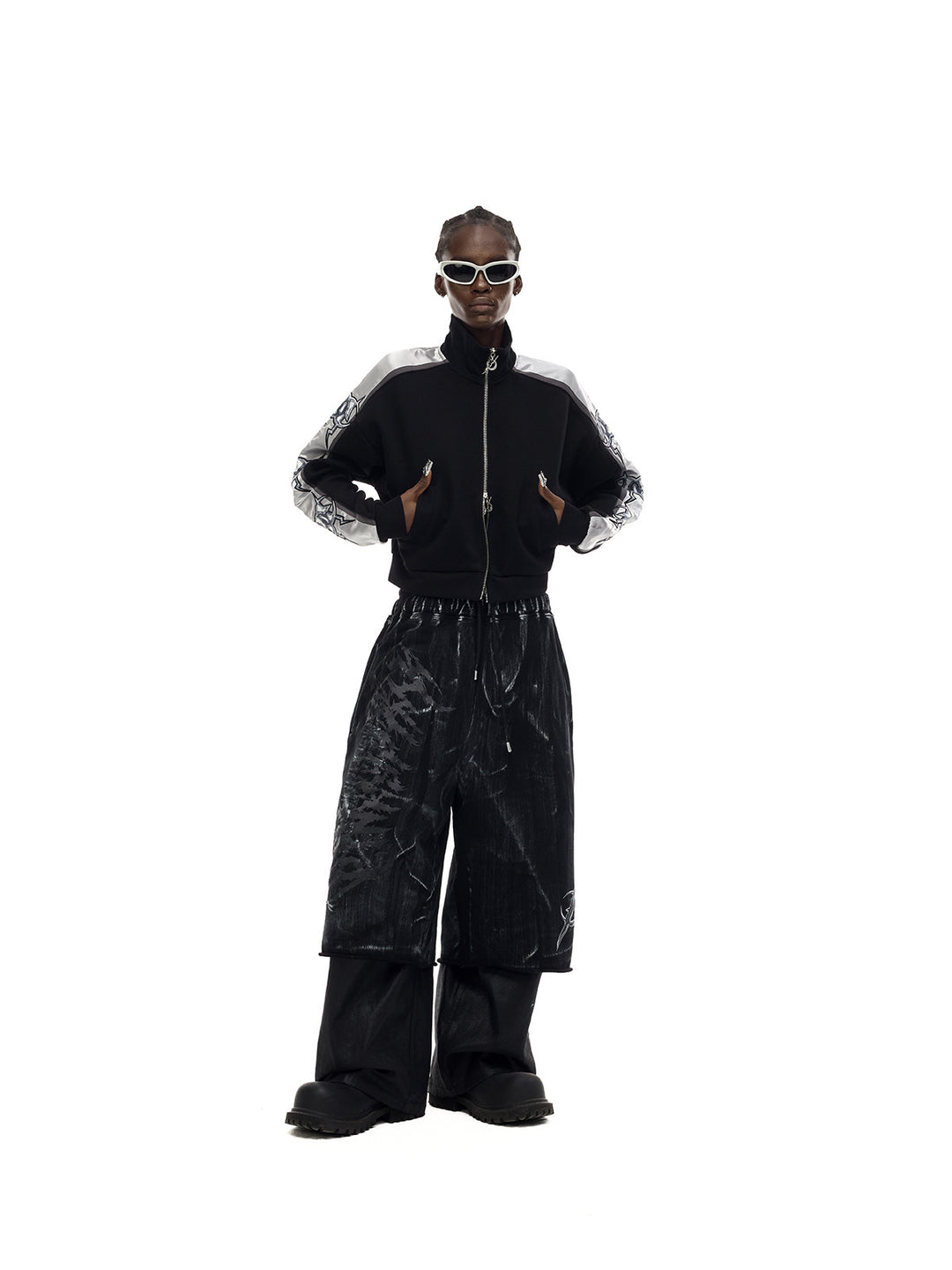 PINKSPINK ELECTRIC MOON coated cropped wide-leg pants in black — front full-length modeled view with hands at the waist