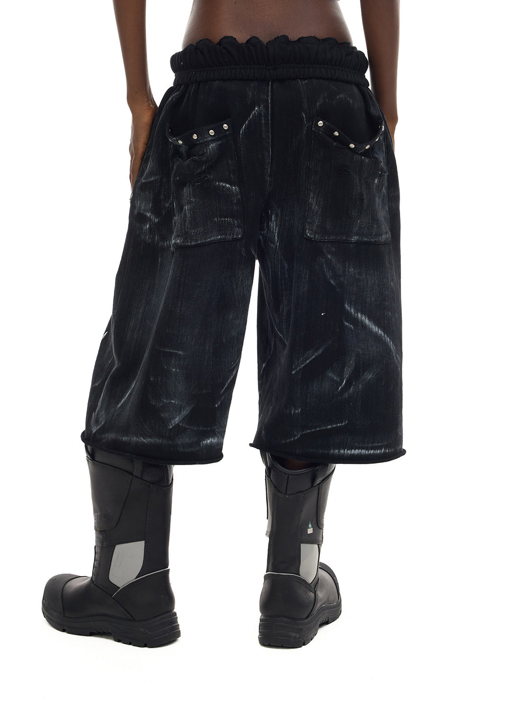 PINKSPINK ELECTRIC MOON coated cropped wide-leg pants in black — rear close-up showing the gathered waist and studded patch pockets
