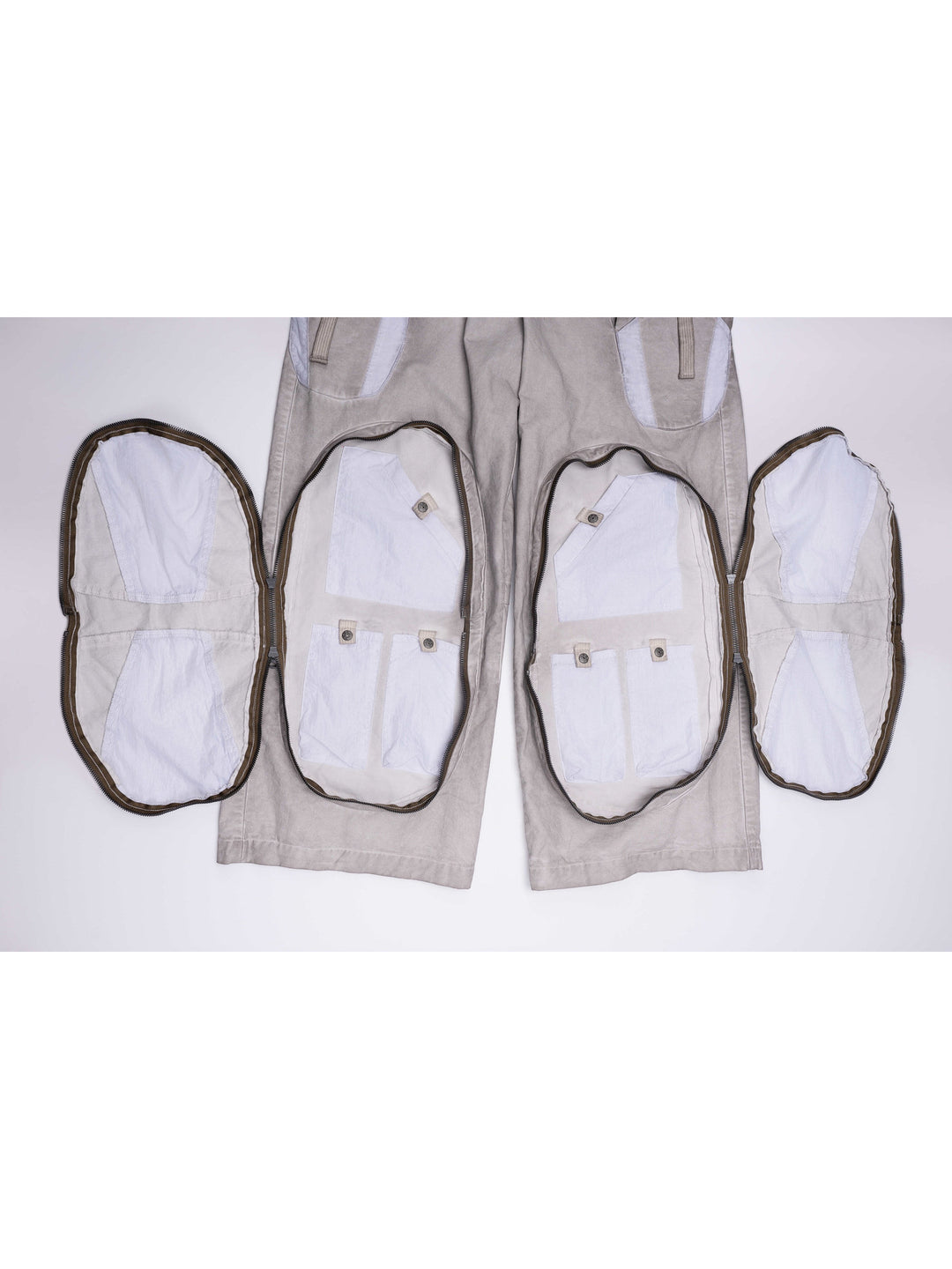 PIONEER eris white welded multi-pocket work pants — garment detail with both large zip-around leg compartments fully open