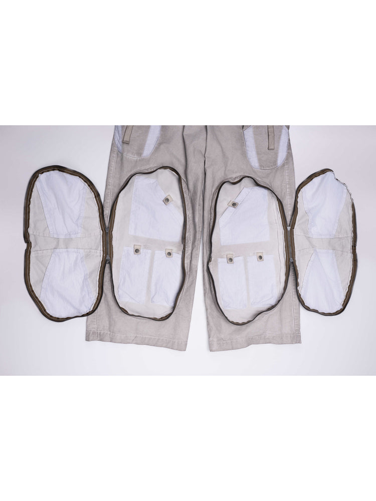 PIONEER eris white welded multi-pocket work pants — garment detail with both large zip-around leg compartments fully open