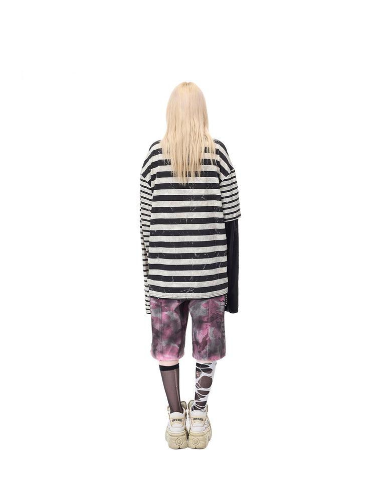 PINKSPINK STATIC asymmetric striped burnout long-sleeve tee in black and white — full-length rear modeled view over separate pink camouflage shorts