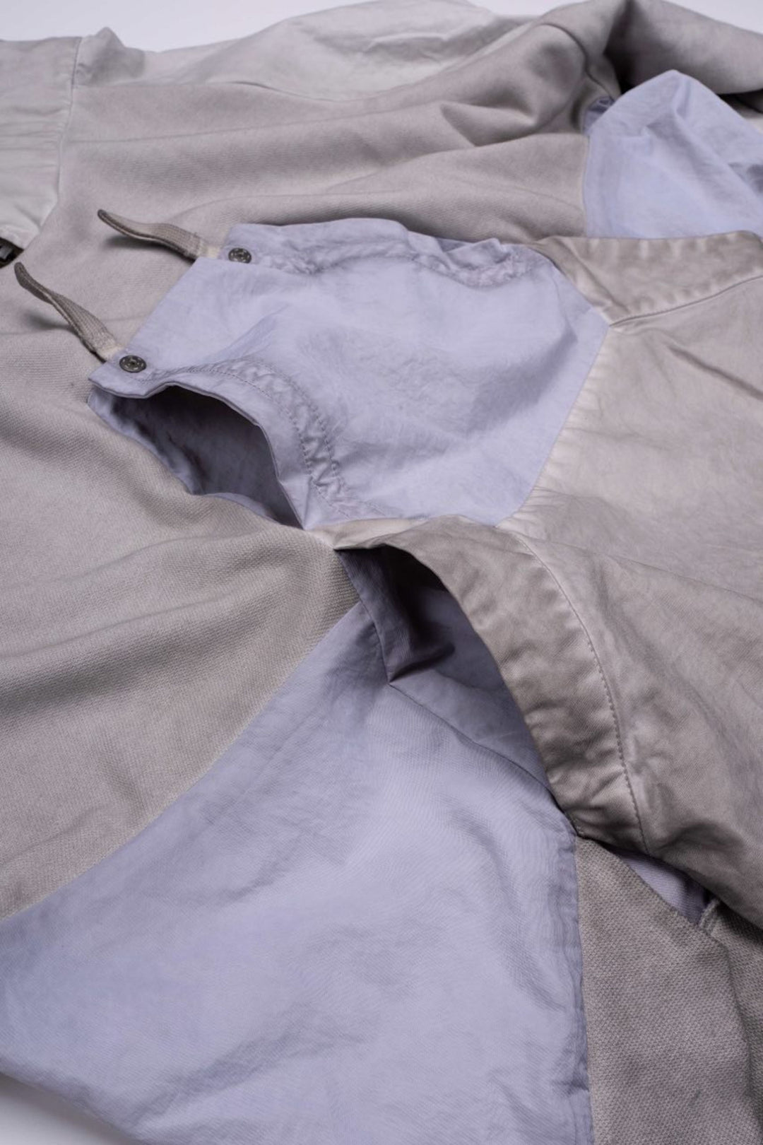 PIONEER eris white detachable-pocket utility hoodie — close-up of the chest pocket folded over to show its opening and snap fasteners