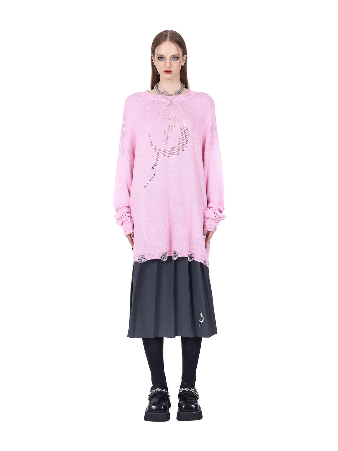 PINKSPINK ELECTRIC MOON distressed open-knit sweater in pink — straight-on loose front view styled over a pleated skirt