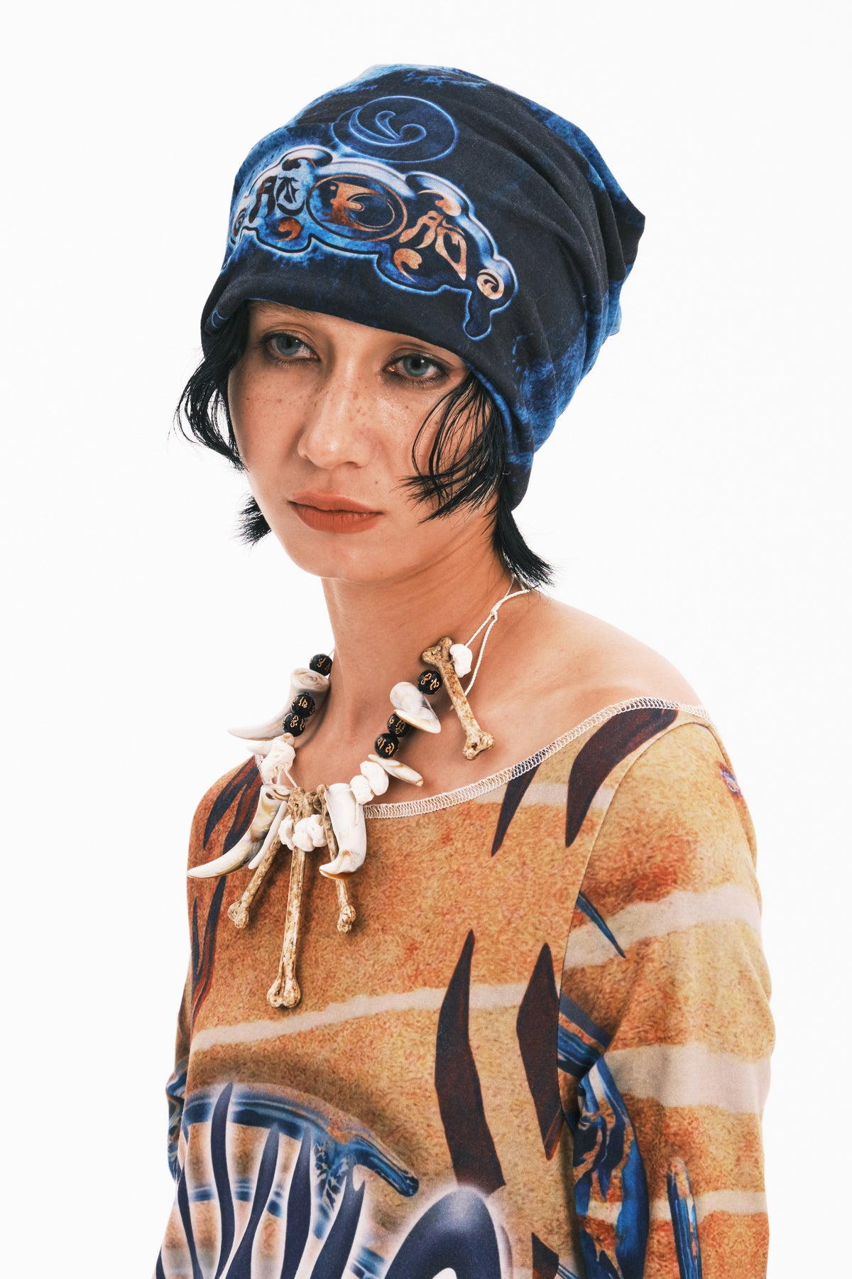 EMBRYO ANCIENT CODE graphic slouch beanie — full-length modeled view