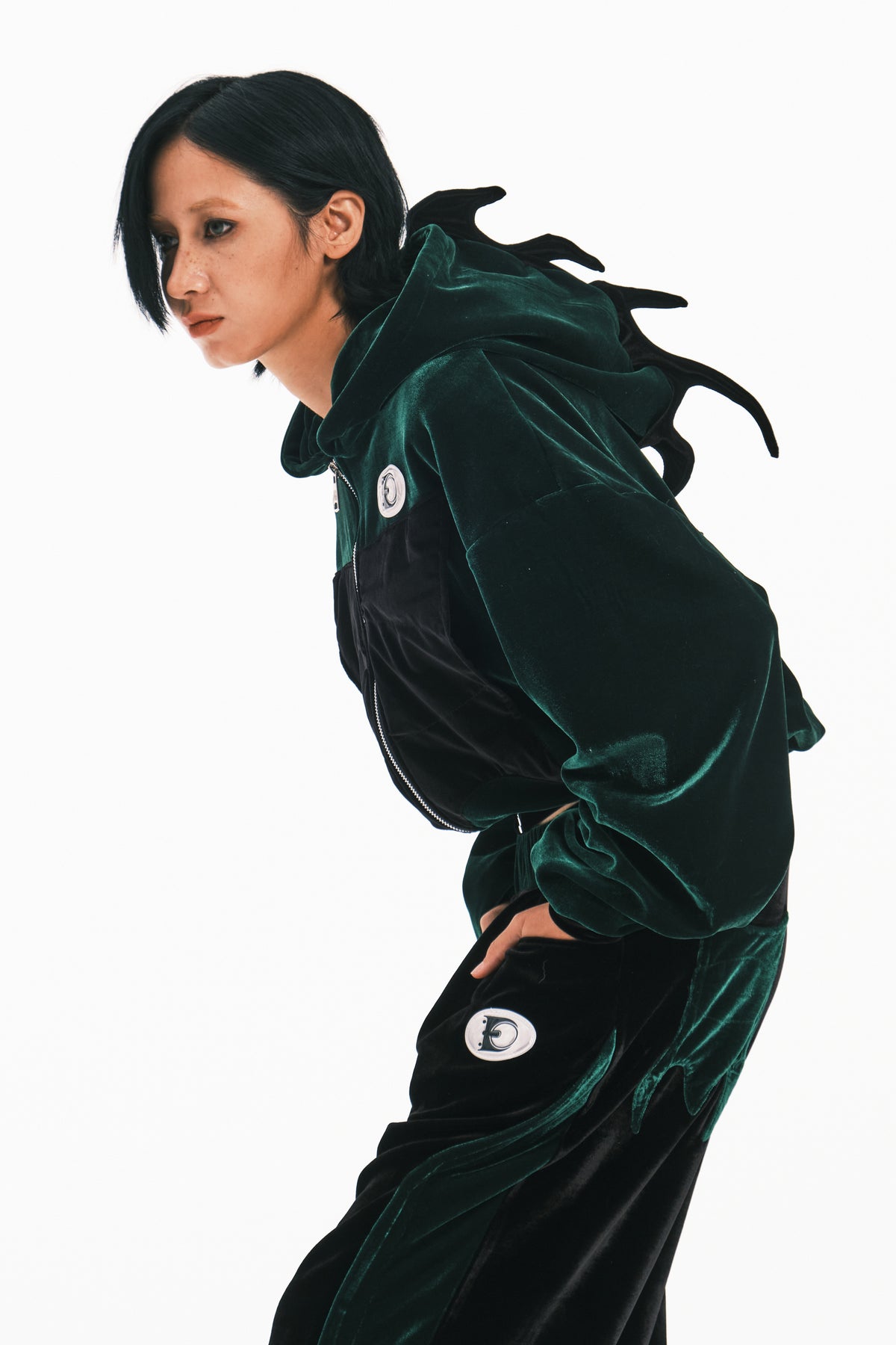 EMBRYO GREEN SPIKE cropped velvet hoodie in green — leaning modeled close-up showing the spiked hood and velvet texture