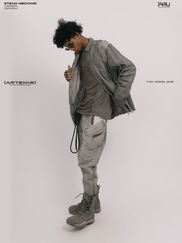 CHAOS ERA moon dust gray raw-edge technical shirt — full-length angled side view holding the shirt open