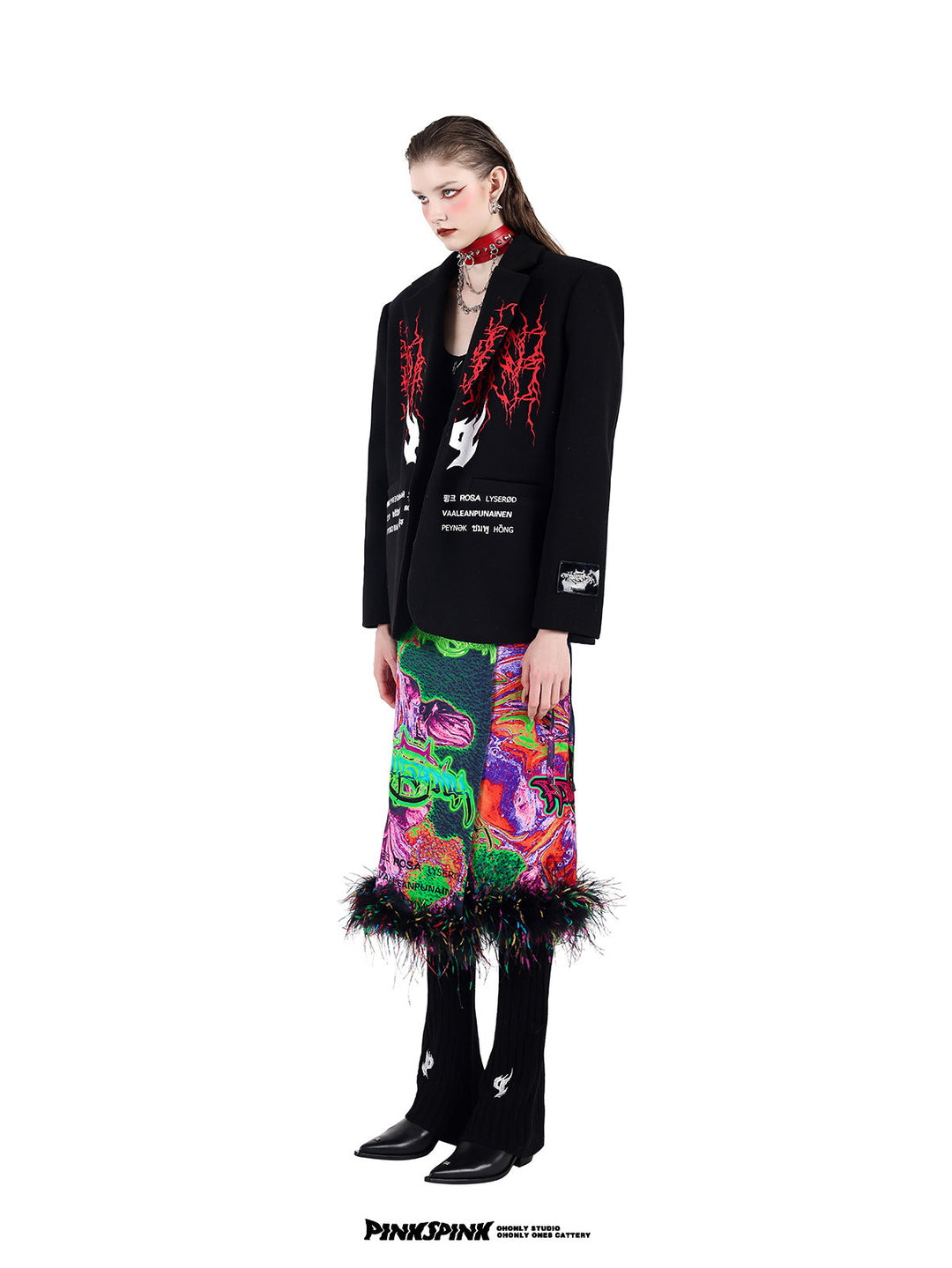 PINKSPINK SPIKE RING studded chain choker in red — three-quarter modeled view with an embroidered blazer and multicolor layered bottoms