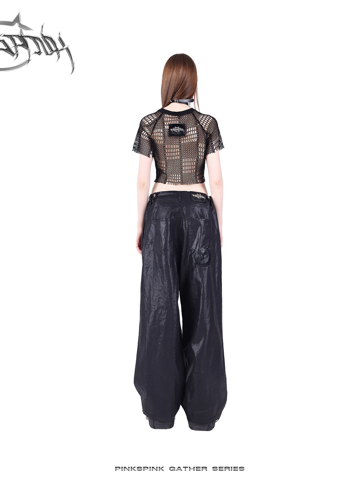 PINKSPINK GEOMETRY open-mesh crop tee in black — rear full-length modeled view showing the back neck label