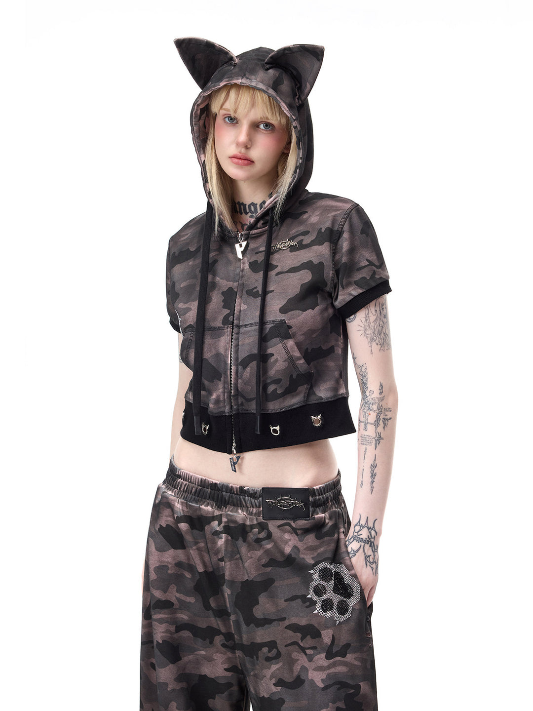 PINKSPINK CATPAW rhinestone curved-leg sweatpants in gray-brown camouflage — cropped outfit view showing the waistband and paw motif beneath a separate hoodie