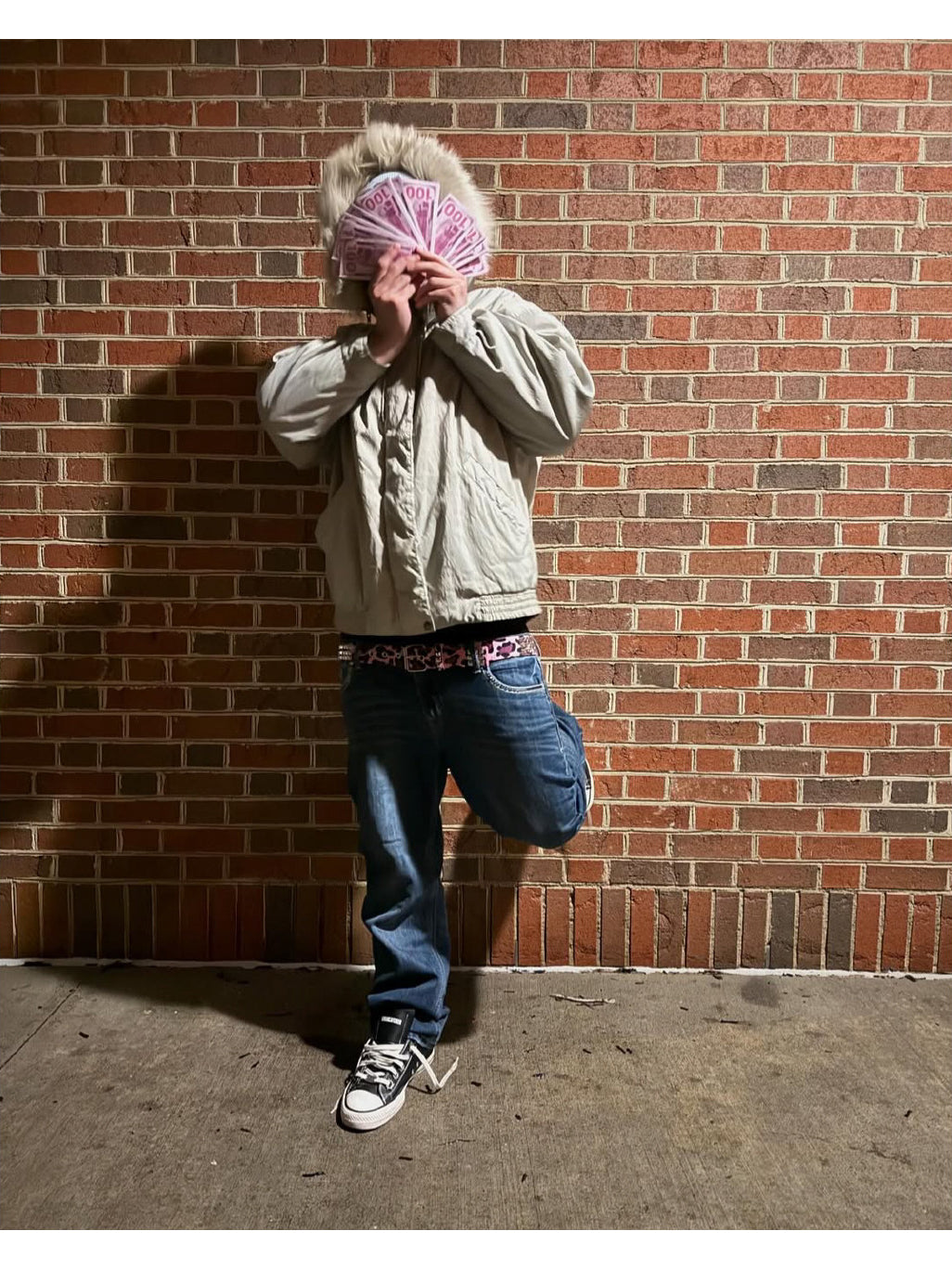ROMAN CATCHER POWSTAR sneakers in black — full-body styling view with blue jeans and a light jacket against a brick wall.