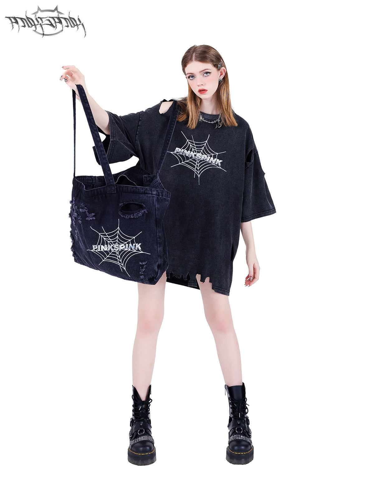 PINKSPINK SPIDER distressed denim shoulder tote — full-length modeled view holding the bag by its long handles