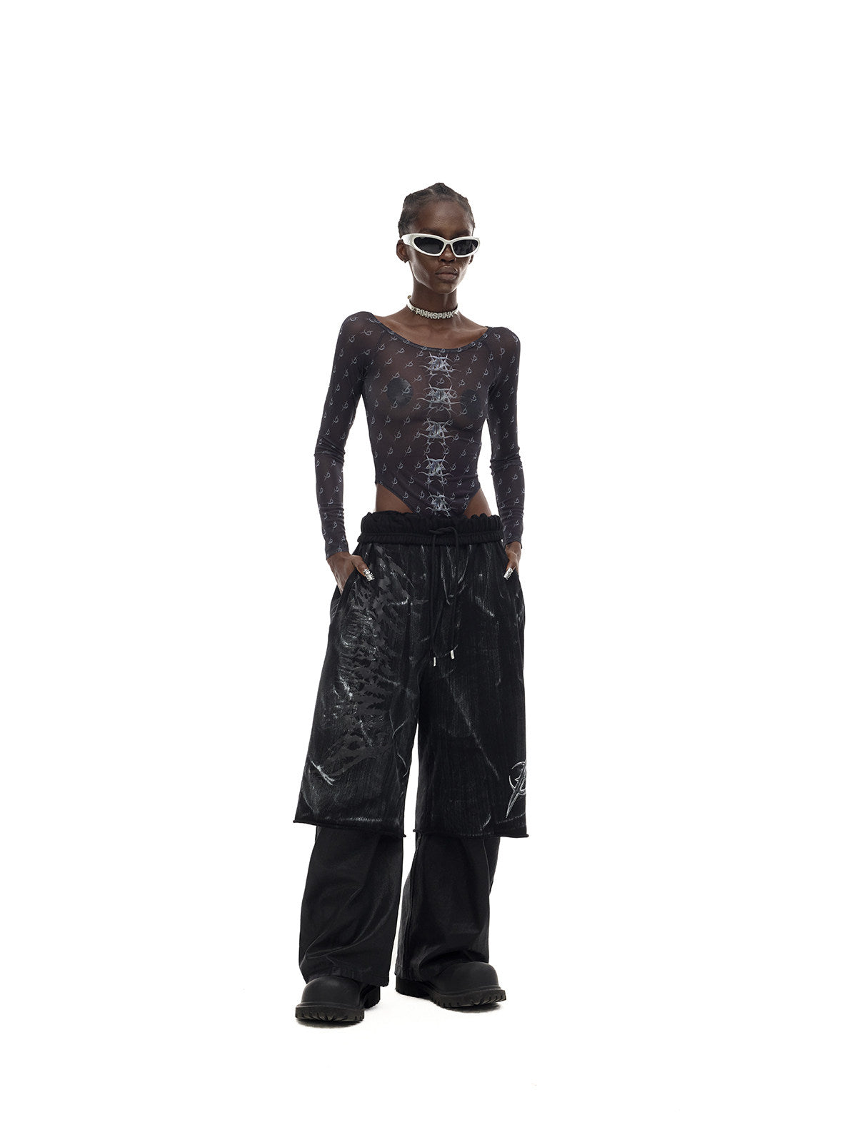 PINKSPINK ELECTRIC MOON coated cropped wide-leg pants in black — front full-length modeled view with a mesh top and separate trouser layer