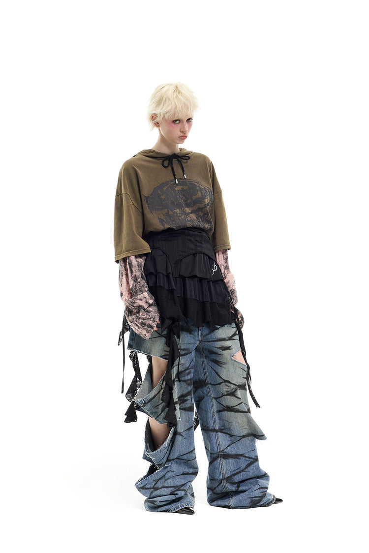 PINKSPINK ELECTRIC MOON two-way layered lace mini dress — black dress worn as a skirt over jeans — angled full-length view