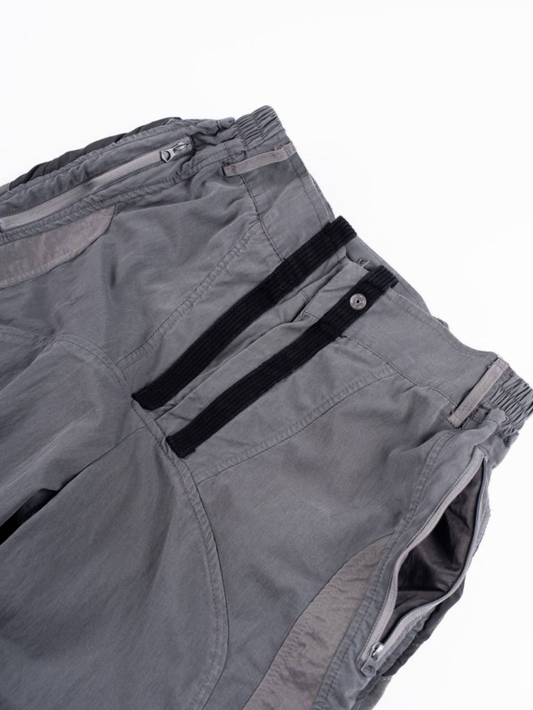 SUPERNOVA alloy gray metallic nylon technical pants — alloy gray close-up of the gathered waistband and zip pocket