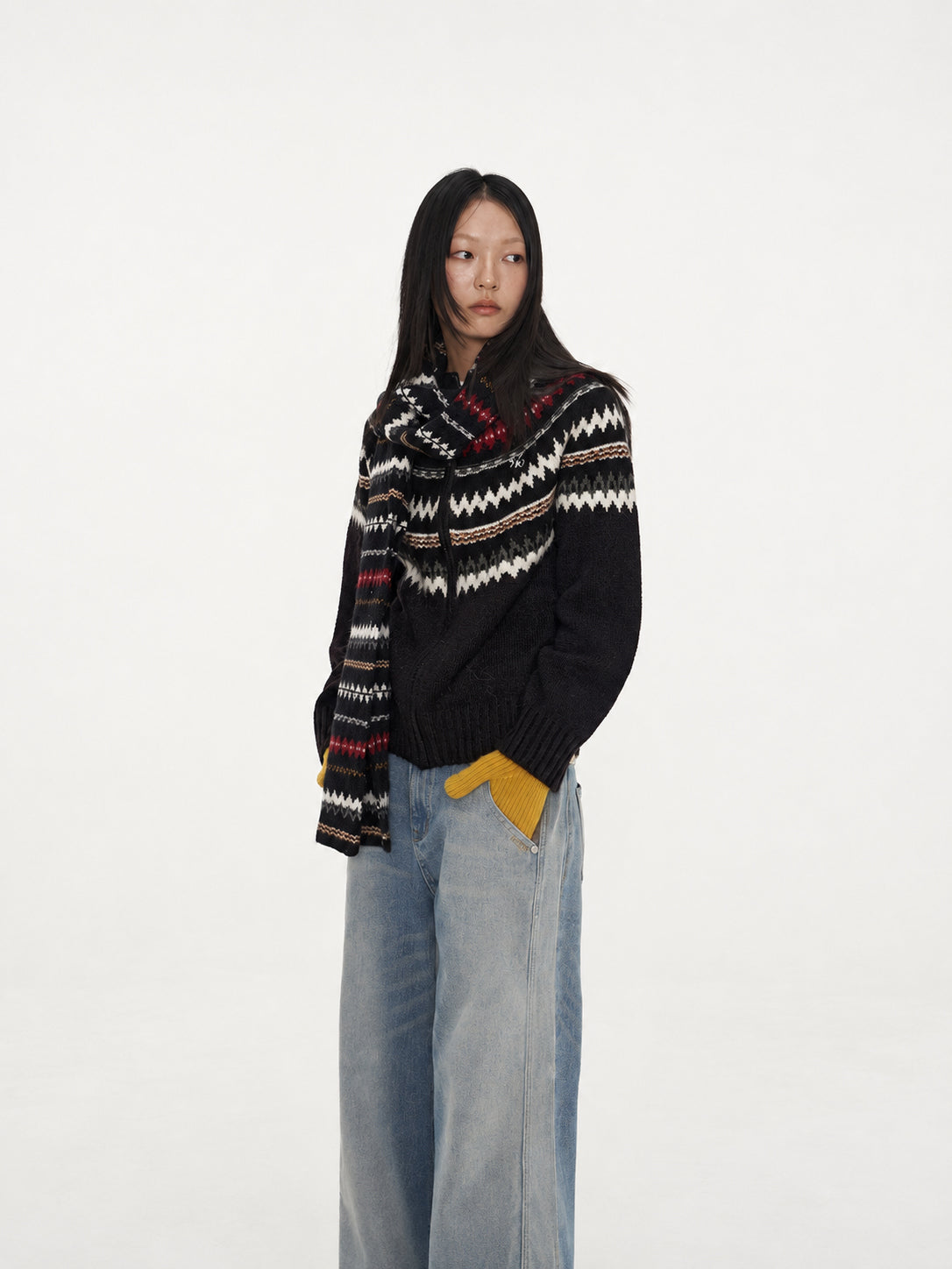 NAWS FAIR ISLE wool-alpaca cardigan in black — three-quarter modeled view with patterned scarf and ribbed cuffs