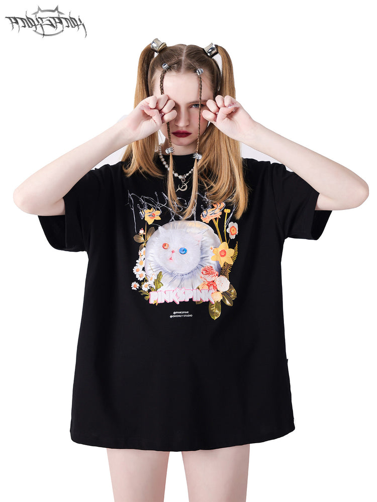 PINKSPINK GARFIELD oversized graphic tee — black upper-body modeled view with hands beside the face