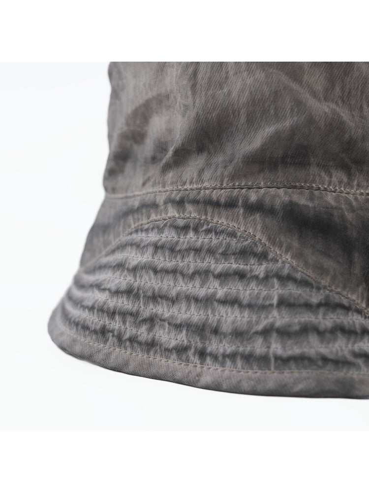 PIONEER distressed nylon bucket hat in moon dust gray — close-up of stitched brim and washed fabric