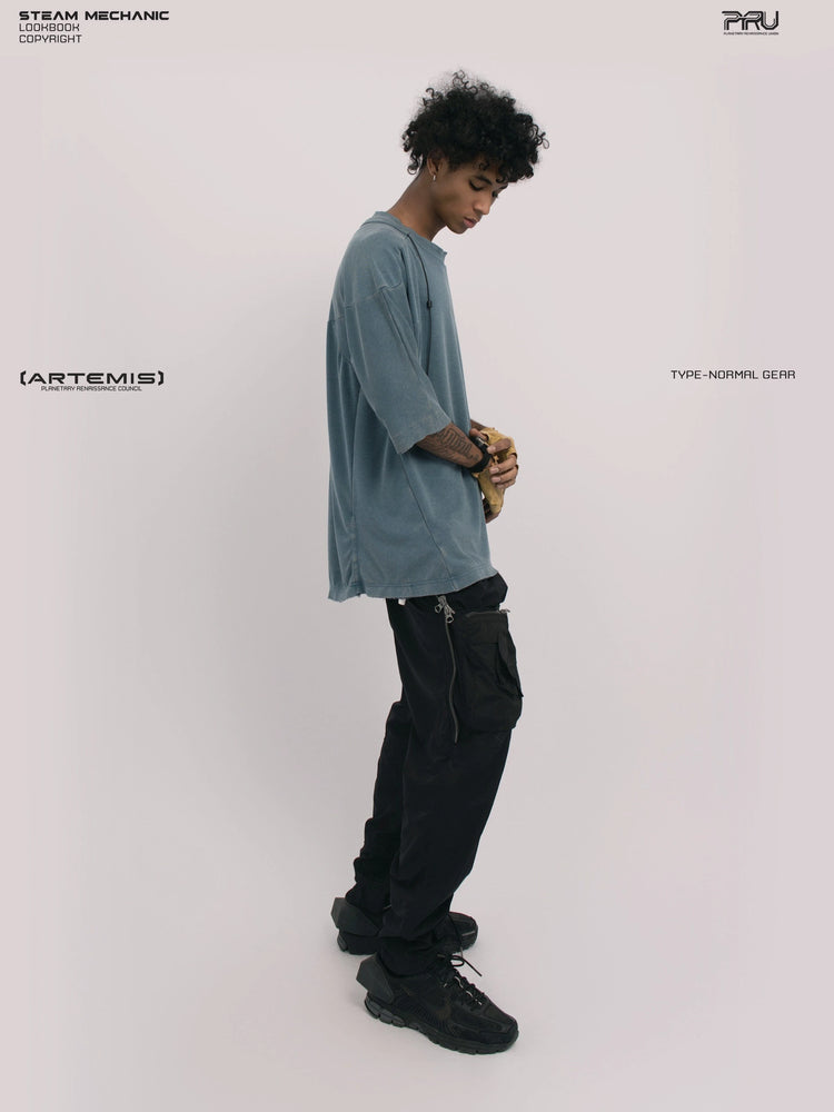 LIGHTSHADOW mycelium blue deconstructed technical tee — full-length side view with hands clasped