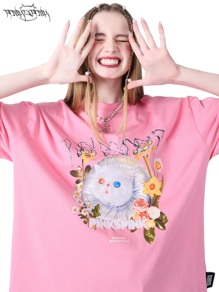 PINKSPINK GARFIELD oversized graphic tee — pink close-up with both hands raised beside the face