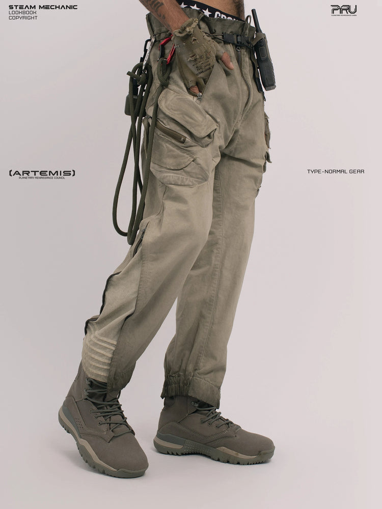 AEGIS lunar soil teal multi-pocket moto pants — front three-quarter modeled view in a relaxed stance