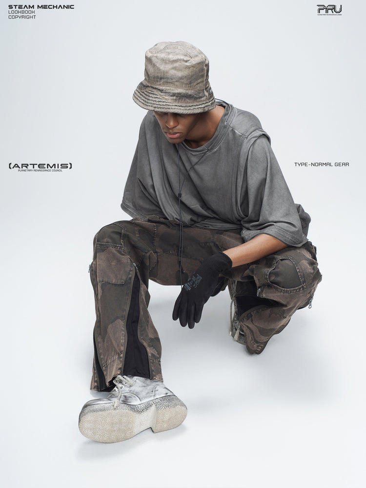 PIONEER mercury brown distressed nylon bucket hat — seated modeled view showing the hat with a dark outfit