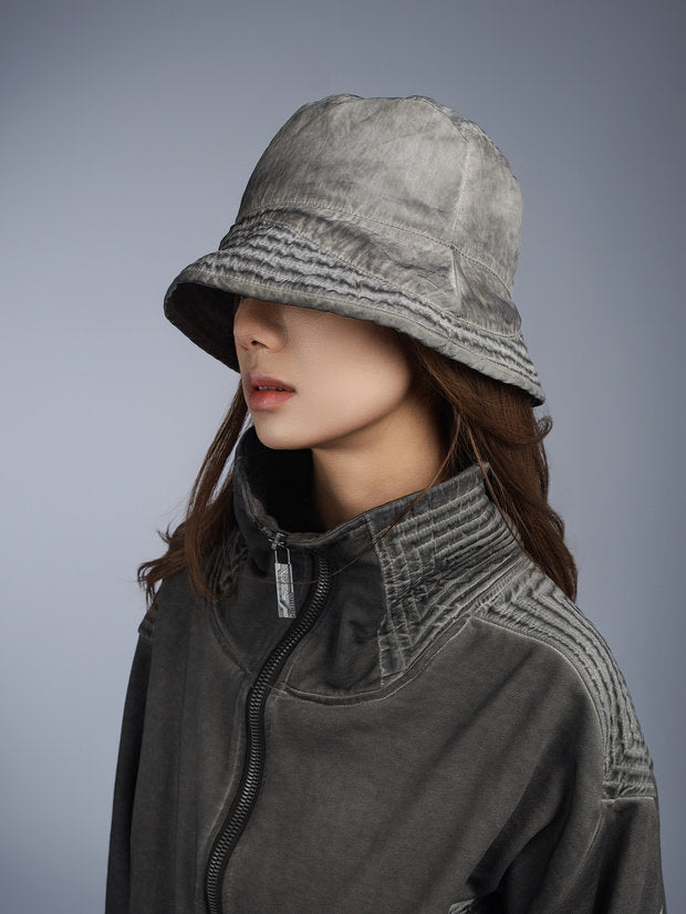 PIONEER distressed nylon bucket hat — moon dust gray opposite three-quarter modeled view
