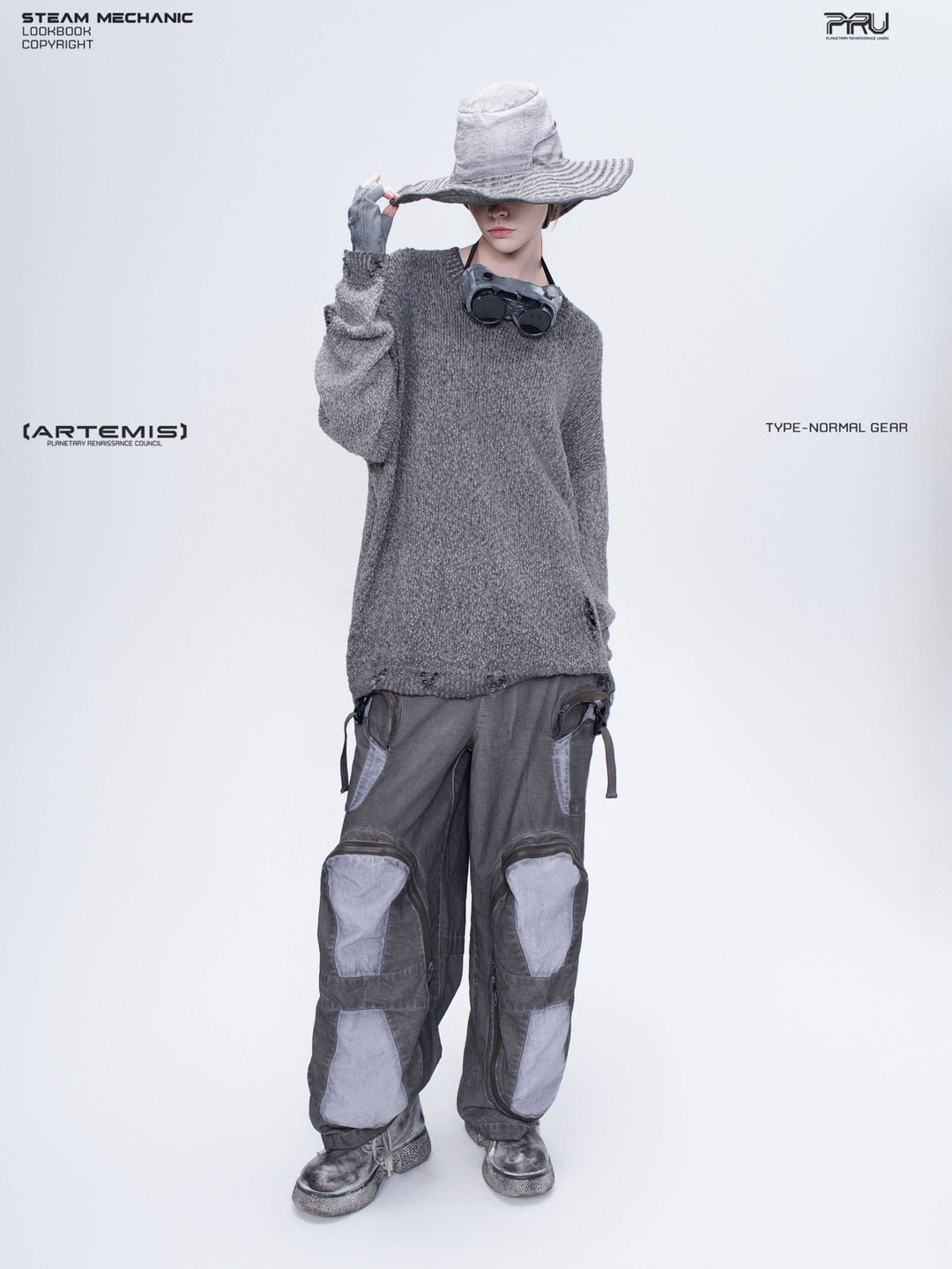 ARTEMIS distressed reversible knit sweater, moon dust gray — full modeled view with one hand on the hat, showing the unbelted length