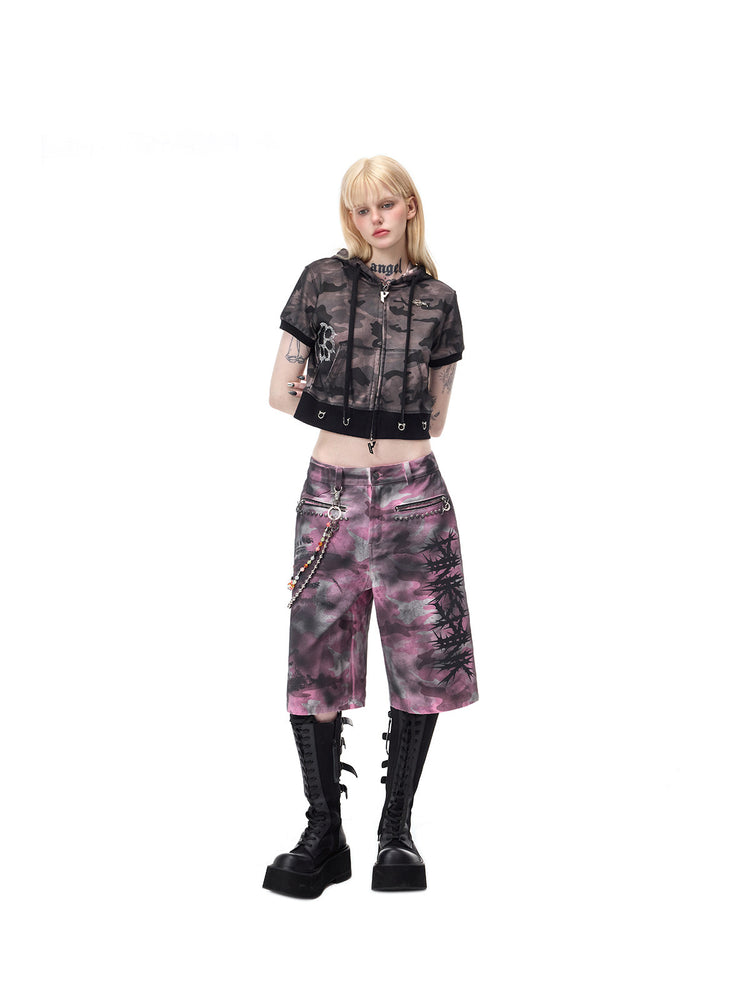 PINKSPINK ELECTRIC MOON coated camouflage denim shorts in pink-gray camouflage — angled full-length view with relaxed wide legs