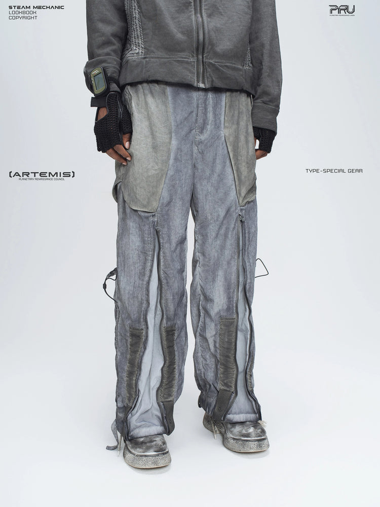 STARCORE moon dust gray engineer utility pants — three-quarter front modeled view with the leg zippers open