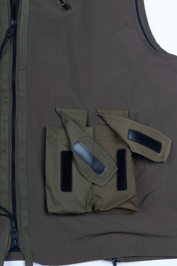 CLERIC utility nylon vest in vine gray green — close-up of the open hook-and-loop pocket flaps