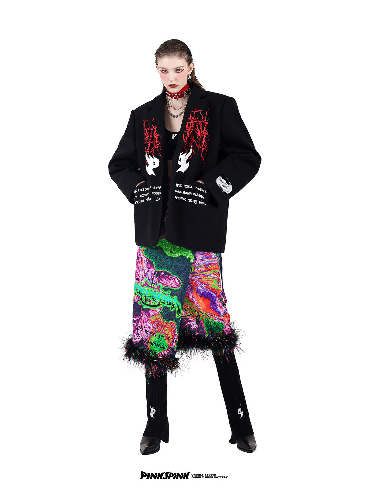 PINKSPINK SPIKE RING studded chain choker in red — front modeled view with hands in pockets and multicolor layered bottoms